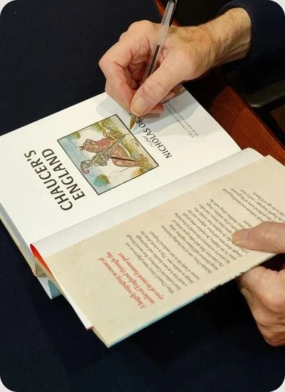 Author signing a book titled 'Chaucer's England'.